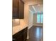 Bright and airy office with large windows, neutral walls, and views of kitchen cabinets and countertops at 1205 Capstone Dr, Durham, NC 27713