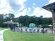 Community pool featuring a splash fountain, sun loungers, and black metal fencing at 1205 Capstone Dr, Durham, NC 27713