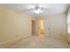 Spacious bedroom with neutral carpet, ceiling fan, and a view of the en-suite bathroom at 1317 Swallow Dr, Raleigh, NC 27606