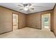 Spacious bedroom with ceiling fan and access to other rooms and outdoors at 1317 Swallow Dr, Raleigh, NC 27606