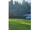 Spacious backyard featuring a shed, mature trees, and a well-maintained lawn at 133 Rustic Ln, Smithfield, NC 27577