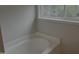 Bathroom with a soaking tub near a window at 133 Rustic Ln, Smithfield, NC 27577