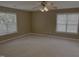 Spacious bedroom with a ceiling fan and two windows with blinds, offering lots of natural light at 133 Rustic Ln, Smithfield, NC 27577