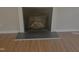Fireplace on a hardwood floor with a dark surround at 133 Rustic Ln, Smithfield, NC 27577