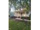 Inviting front porch with white railing, brick steps, and lush landscaping at 133 Rustic Ln, Smithfield, NC 27577