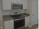 Updated kitchen featuring stainless steel appliances and white cabinetry at 133 Rustic Ln, Smithfield, NC 27577