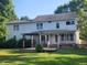 Expansive back of house with large windows, a deck, and a pergola at 133 Rustic Ln, Smithfield, NC 27577