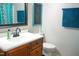 Bathroom vanity with a framed mirror, accenting towels, and chalkboard decoration provides an updated look at 1423 Alderman Cir, Raleigh, NC 27603