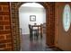 Dining area with dark floors and brick archway at 1423 Alderman Cir, Raleigh, NC 27603