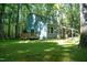 Quaint two-story home nestled among mature trees on a sunny lot at 1423 Alderman Cir, Raleigh, NC 27603