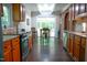 Eat-in kitchen with stainless appliances, stone backsplash, and outdoor access at 1423 Alderman Cir, Raleigh, NC 27603