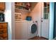 Laundry room with a washer and dryer as well as wooden cabinets and storage area at 1423 Alderman Cir, Raleigh, NC 27603