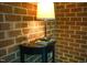 Living area featuring a black table with a small lamp providing soft lighting near a brick wall at 1423 Alderman Cir, Raleigh, NC 27603