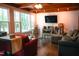 Cozy living room with hardwood floors, beamed ceiling and large windows at 1423 Alderman Cir, Raleigh, NC 27603