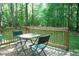 Outdoor deck featuring a patio set and views of the surrounding trees at 1423 Alderman Cir, Raleigh, NC 27603