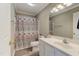 Bathroom featuring single sink vanity and shower with patterned curtain at 1749 Conners Ct, Burlington, NC 27215