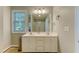 Bathroom features a double sink vanity, a large mirror, and tile floors at 1749 Conners Ct, Burlington, NC 27215