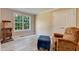 Cozy bedroom with wood floors, a large window, and a comfortable reading chair at 1749 Conners Ct, Burlington, NC 27215