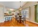 Cozy dining area features hardwood floors, a chandelier, and a view to the kitchen at 1749 Conners Ct, Burlington, NC 27215