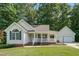 Charming home with inviting porch and attached garage, surrounded by mature trees at 1749 Conners Ct, Burlington, NC 27215