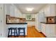 The kitchen features white cabinets, tile countertops, and hardwood floors at 1749 Conners Ct, Burlington, NC 27215
