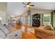 Open-concept living room boasts hardwood floors, vaulted ceilings, and a cozy fireplace at 1749 Conners Ct, Burlington, NC 27215