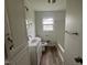 Well-lit bathroom featuring a white vanity, mirror, and tub with shower at 1851 S Clearview Dr, Henderson, NC 27536