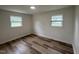 Bright bedroom with hardwood floors, white walls and trim, and dual windows at 1851 S Clearview Dr, Henderson, NC 27536