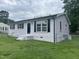 Side view of a light-colored home with black shutters and a chain-link fence at 1851 S Clearview Dr, Henderson, NC 27536
