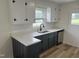 Updated kitchen featuring subway tile backsplash, updated cabinets, new countertops and stainless steel dishwasher at 1851 S Clearview Dr, Henderson, NC 27536