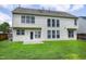 A spacious backyard is shown with a lush green lawn, surrounded by a wooden fence and the exterior of a two-story home at 201 Masterwood Way, Morrisville, NC 27560
