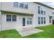 A two-story home features a door to the backyard from a concrete patio surrounded by a grassy lawn at 201 Masterwood Way, Morrisville, NC 27560