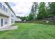 Large backyard featuring a lush lawn, wooden fence, and mature trees, offering both privacy and a tranquil, natural environment at 201 Masterwood Way, Morrisville, NC 27560