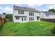 A spacious backyard is shown with a lush green lawn, surrounded by a wooden fence and the exterior of a two-story home at 201 Masterwood Way, Morrisville, NC 27560