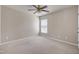 Simple bedroom featuring a ceiling fan, window, neutral color palette, and carpeted floors at 201 Masterwood Way, Morrisville, NC 27560