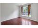 Sunlit bedroom featuring hardwood floors, neutral walls, and a large window at 201 Masterwood Way, Morrisville, NC 27560