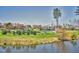 A community offers recreational area with tennis courts, playground, clubhouse, and pond surrounded by lush greenery and trees at 201 Masterwood Way, Morrisville, NC 27560