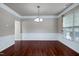 Open dining room with hardwood flooring, paneled walls, and a chandelier at 201 Masterwood Way, Morrisville, NC 27560