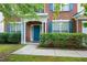 A close up of the brick home's entryway, showcasing the covered porch, front door, and trimmed hedges at 201 Masterwood Way, Morrisville, NC 27560