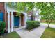 A view of the brick home's covered entryway, front door, and trimmed landscaping at 201 Masterwood Way, Morrisville, NC 27560