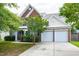 Traditional brick home featuring an attached two-car garage and well-manicured landscaping at 201 Masterwood Way, Morrisville, NC 27560