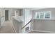 Hallway with stairs and view to the living room with large windows at 201 Masterwood Way, Morrisville, NC 27560