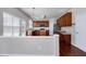 Cozy kitchen with wood cabinets, an island, stainless steel appliances, and hardwood floors at 201 Masterwood Way, Morrisville, NC 27560