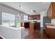Sunlit kitchen features wood cabinets, an island, stainless steel appliances, and an eat-in area at 201 Masterwood Way, Morrisville, NC 27560