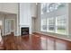 Open living room with fireplace, high ceilings, hardwood floors, and abundant natural light at 201 Masterwood Way, Morrisville, NC 27560