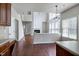 Open-concept living room features a fireplace, tall windows, and hardwood floors at 201 Masterwood Way, Morrisville, NC 27560