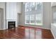 Bright living room with fireplace, hardwood floors, and large windows at 201 Masterwood Way, Morrisville, NC 27560