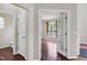 Bright living room featuring hardwood floors, neutral walls, and a view through French doors at 201 Masterwood Way, Morrisville, NC 27560
