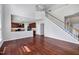 Open-concept living room with hardwood floors, stairs, and a kitchen at 201 Masterwood Way, Morrisville, NC 27560