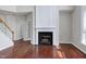 Cozy living room featuring hardwood floors, a fireplace, and staircase at 201 Masterwood Way, Morrisville, NC 27560